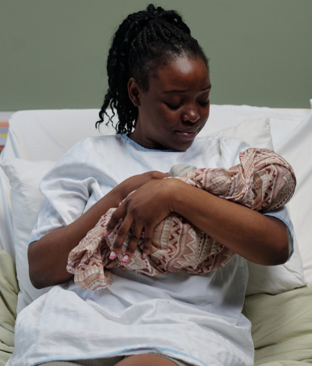A mother holding her newborn in the hospital